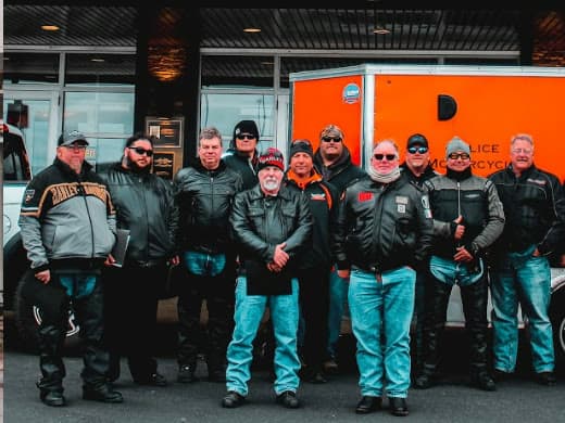 A ProRider class in full riding gear standing together outside the training venue